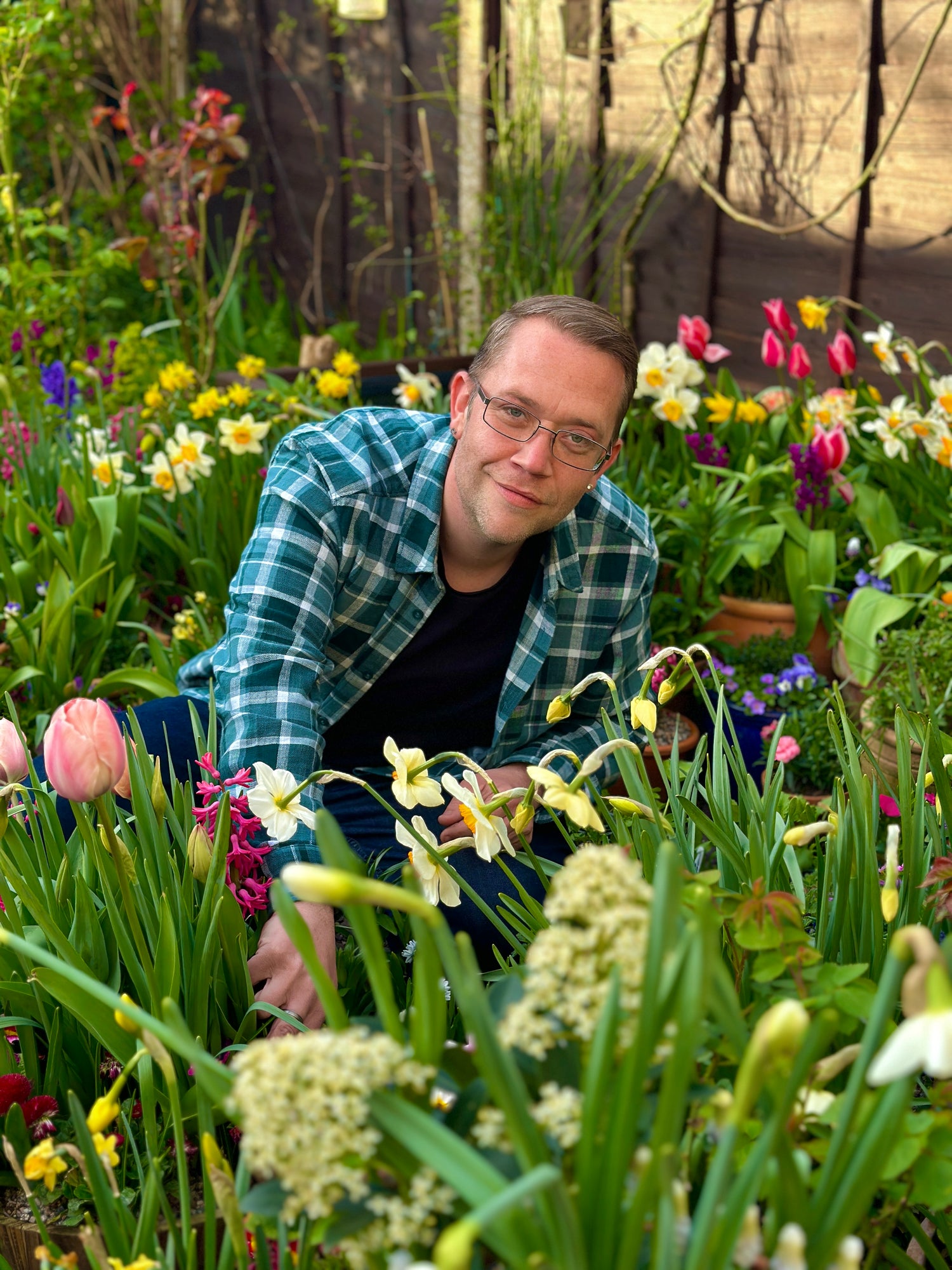 Chris in his Spring garden with Tulip and Daffodils flowers surrounding him.